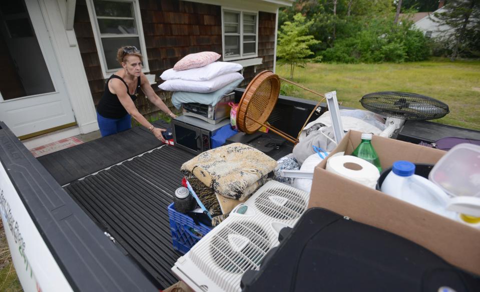 Alessandra Dabliz finishes loading up a rental truck with family belongings. Following a court proceeding, Dabliz and her brother were evicted from 51 Dunns Pond Road in Hyannis.