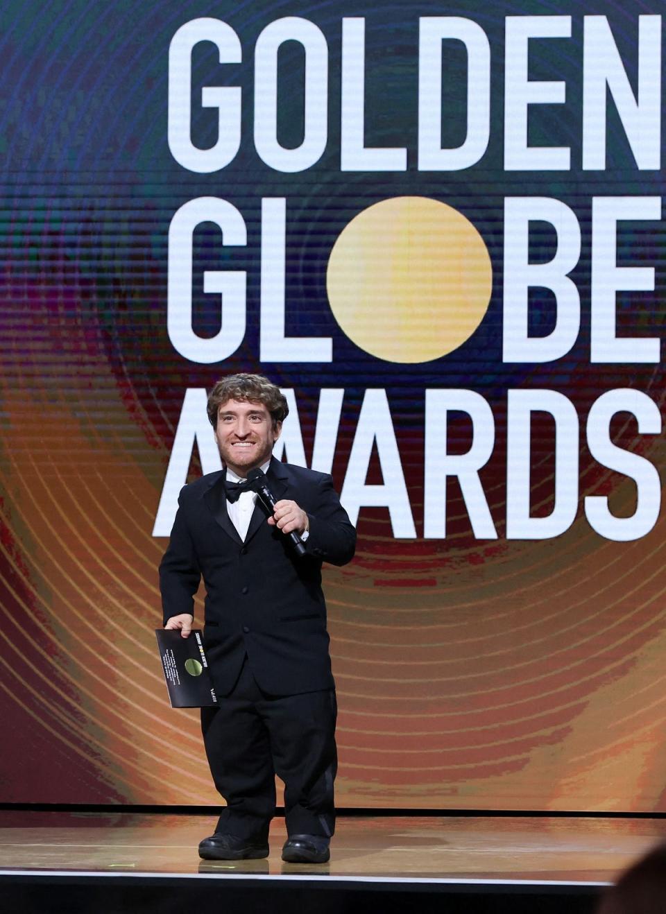 HFPA Grantee and Founder and Director of the Easterseals Disability Film Challenge Nic Novicki presenting the Best Actor in a Motion Picture Drama Award onstage during the 79th Annual Golden Globe Awards (HFPA/AFP via Getty Images)