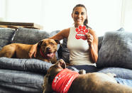 <p>Alex Morgan poses with her rescue dogs and a paw print that she signed in honor of them for Stella and Chewy's National Adopt a Senior Pet Month Program on Wednesday. </p>