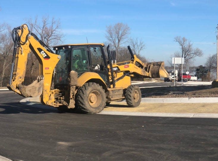 An earthmover was used Thursday morning to help put the final touches on a roundabout recently built at the site where S.E. 45th Street intersections with S.E. West Edge Road on the north and S.E. Berryton Road on the south.