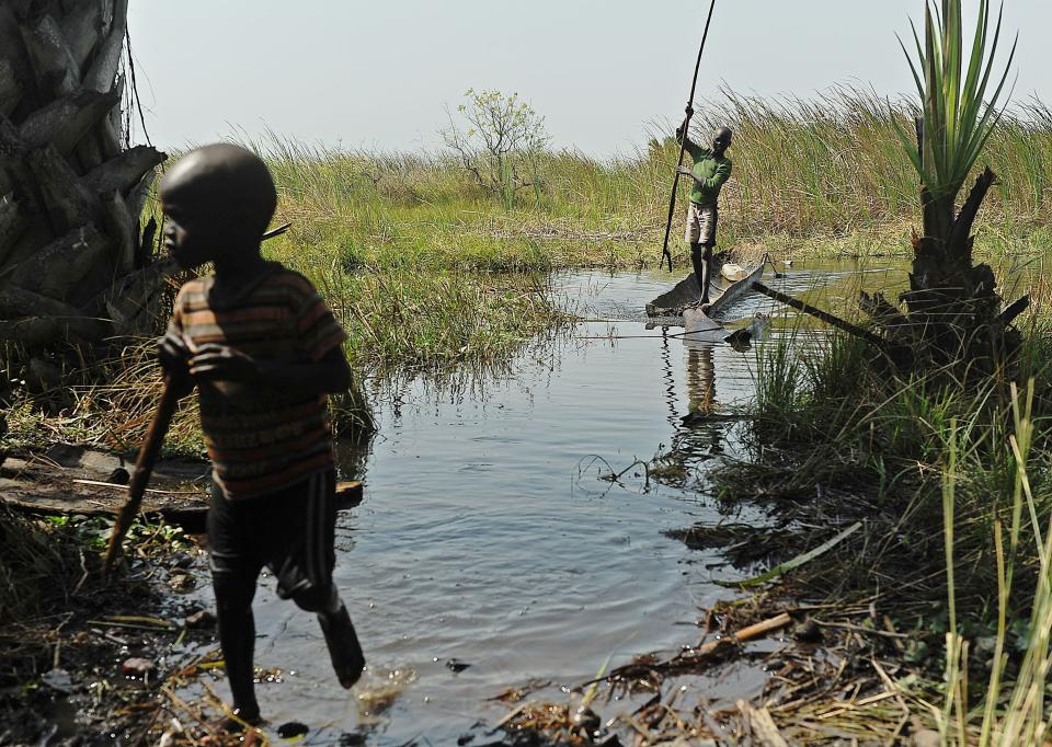 Children play in the water on Feb. 21, 2014, just off one of the islands in the Sudd swamplands in Unity state, central South Sudan, where they have fled with their families for safety. (Photo: TONY KARUMBA via Getty Images)