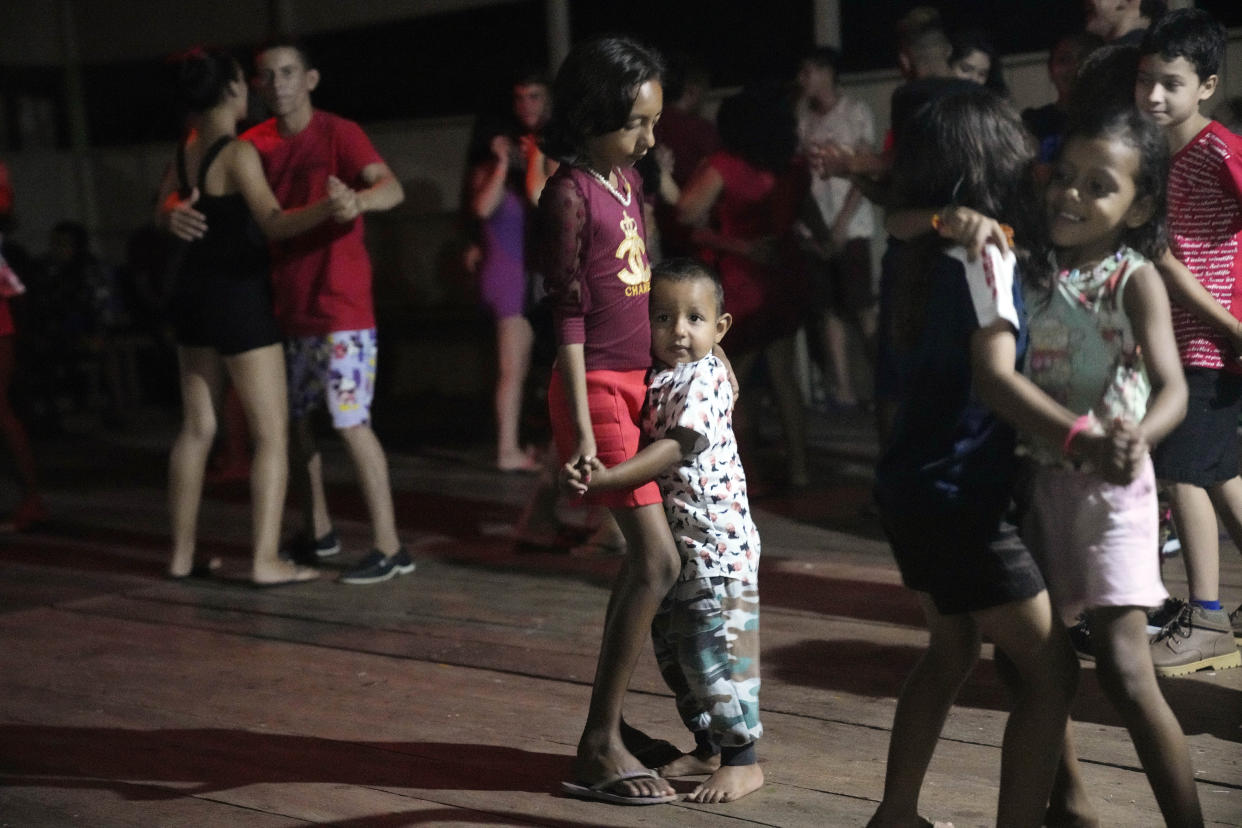 Children participate in a fishermen party at San Raimundo settlement communal hall, Carauari, Brazil, Monday, Sept. 5, 2022. Thirty-four families call the area home. (AP Photo/Jorge Saenz)