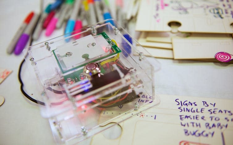 Photo showing pens, tech and paper puzzle pieces.