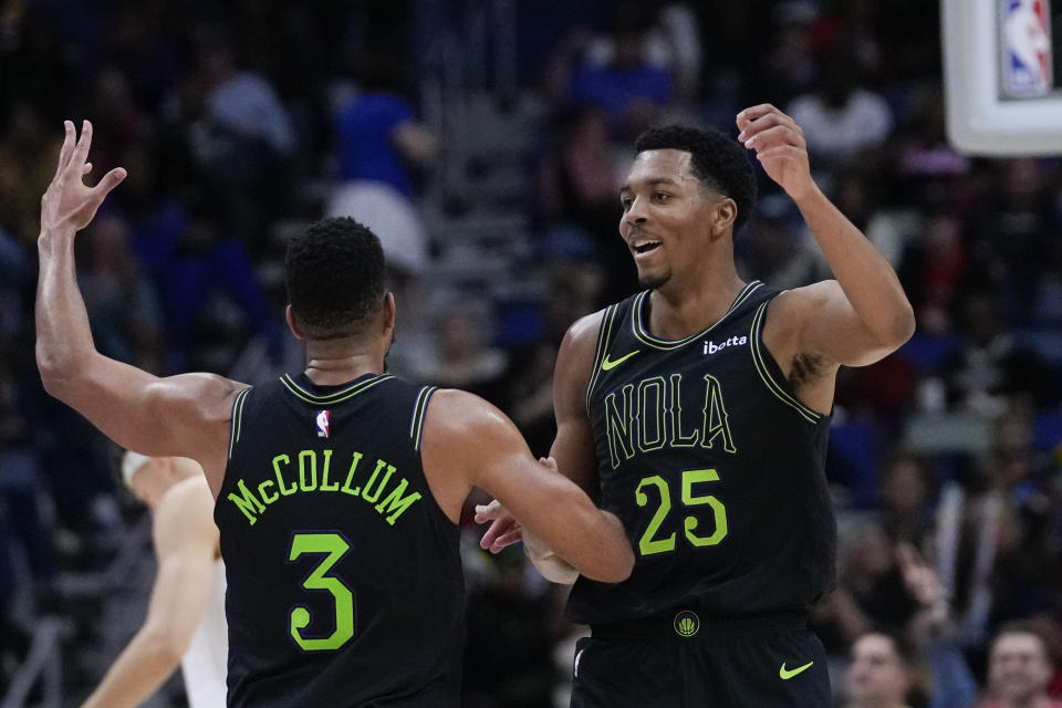 New Orleans Pelicans guard Trey Murphy III (25) celebrates his 3-point shot with guard CJ McCollum (3) in the second half of an NBA basketball game against the San Antonio Spurs in New Orleans, Friday, Dec. 1, 2023. The Pelicans won 121-106. (AP Photo/Gerald Herbert)