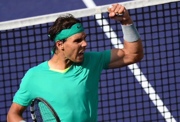 Rafael Nadal celebrates after winning a point against Juan Martin Del Potro at the Indian Wells in California on March 17, 2013. Nadal won 4-6, 6-3, 6-4 to win his third Indian Wells ATP Masters title and cement his return from a seven-month injury layoff