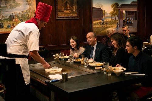 (L-R): Bryan Connerty (Toby Leonard Moore) whips up a meal for Chuck Rhoades (Paul Giamatti) and Wendy Rhoades (Maggie Siff), flanked by the one-time couple's two children.