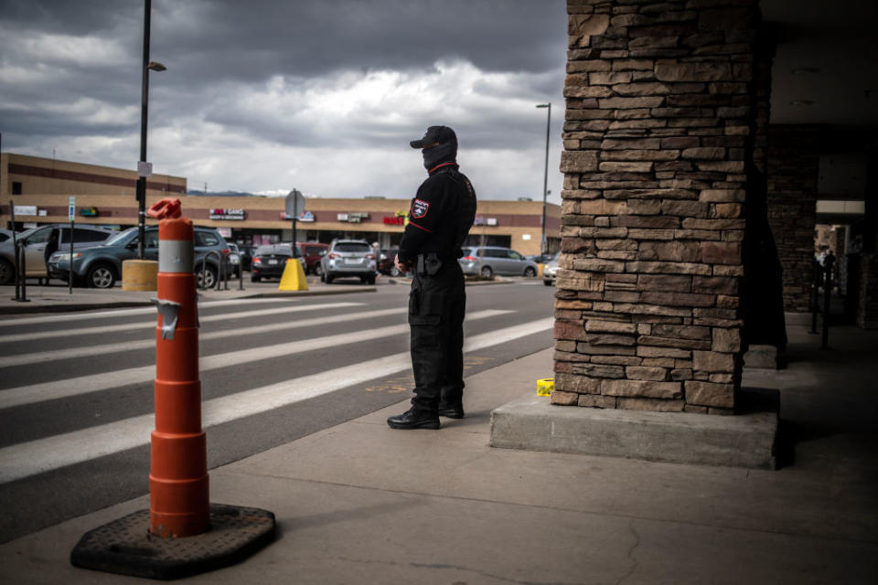 Armed security watches over a King Soopers grocery store on March 26, 2021, in Boulder, Colorado. Some residential and commercial areas are hiring armed security to combat public safety issues. (Photo by Chet Strange—Getty Images)