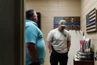 Daniel Guess, left, talks with Wheeler Lovelady, right, an investigator from the Lawrence County Sheriff's office on Friday, June 24, 2022, in Moulton, Ala. According to the police, David Guess, Daniel's brother, was shot with a handgun and burned in a wooded area with tires piled on his body and set on fire. He was dumped in an Alabama forest near a place called Chicken Foot Mountain. (AP Photo/Brynn Anderson)