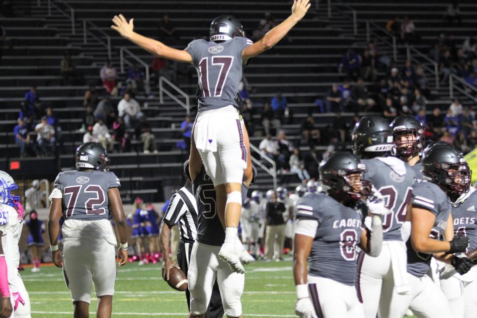 Savannah (Ga.) Benedictine Military School quarterback Luke Kromenhoek, who is verbally committed to Florida State's 2024 recruiting class, gets lifted up by a teammate against Burke County.