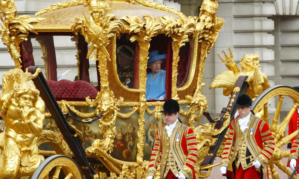 Queen Elizabeth looking out from the gold state coach.