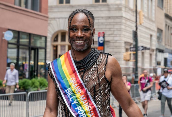 Billy smiling and wearing a Pride "Grand Marshal" sash