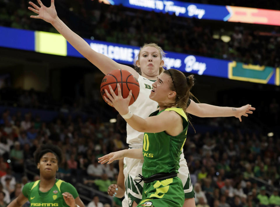 Oregon guard Sabrina Ionescu (20) drives to the basket as Baylor forward Lauren Cox (15), defends during a Final Four semifinal of the NCAA women’s college basketball tournament Friday, April 5, 2019, in Tampa, Fla. (AP Photo/Chris O'Meara)