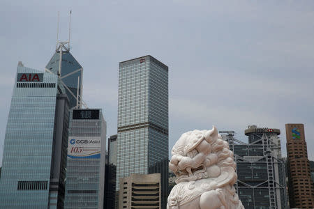 A lion sculpture is seen in front of office towers at the financial Central district in Hong Kong, China May 25, 2017. REUTERS/Bobby Yip