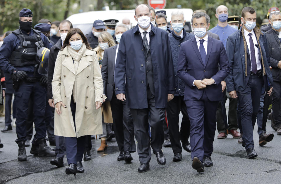 From the left, Paris mayor Anne Hidalgo, France Prime Minister Jean Castex, and Interior Minister Gerald Darmanin arrive on the scene after a knife attack near the former offices of satirical newspaper Charlie Hebdo, Friday Sept. 25, 2020 in Paris. French terrorism authorities are investigating a knife attack that wounded at least two people Friday near the former offices of the satirical newspaper Charlie Hebdo in Paris, authorities said. A suspect has been arrested. (AP Photo/Lewis Joly)