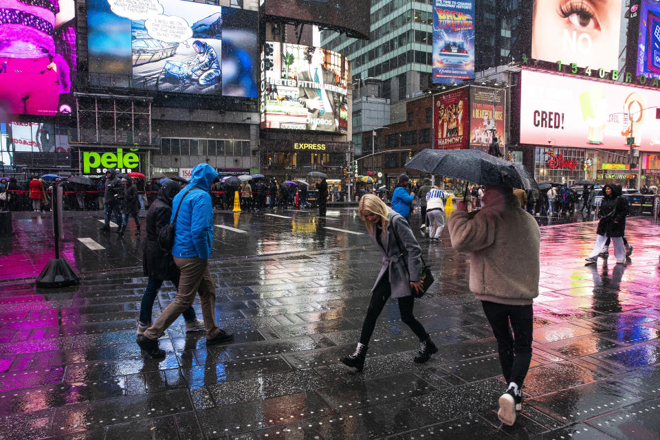 People walk around Times Square during a winter storm in New York Sunday, Jan. 7, 2024. (AP Photo/Eduardo Munoz Alvarez)