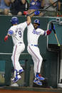 Texas Rangers' Isiah Kiner-Falefa (9) celebrates his two-run home run against the Minnesota Twins with Adolis Garcia, right, during the third inning of a baseball game Saturday, June 19, 2021, in Arlington, Texas. (AP Photo/Michael Ainsworth)