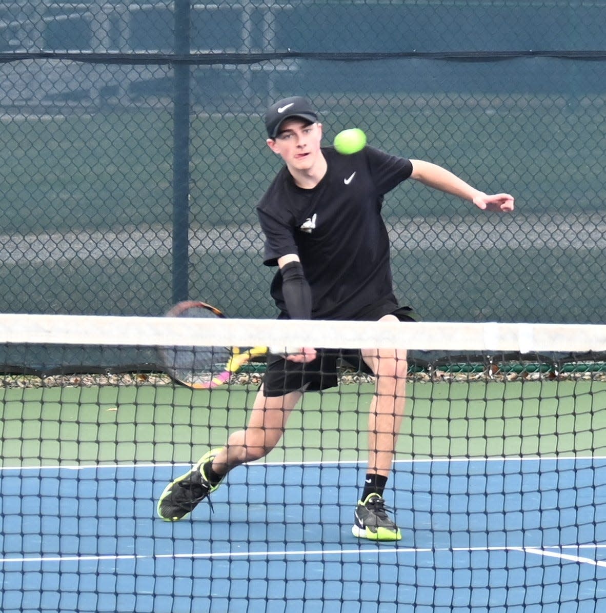 Lexington's Dylan Catanese returns a shot during an early-season match this spring.