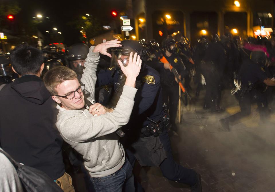 Police officers scuffle with protesters during a protest against police violence in the U.S., in Berkeley, California