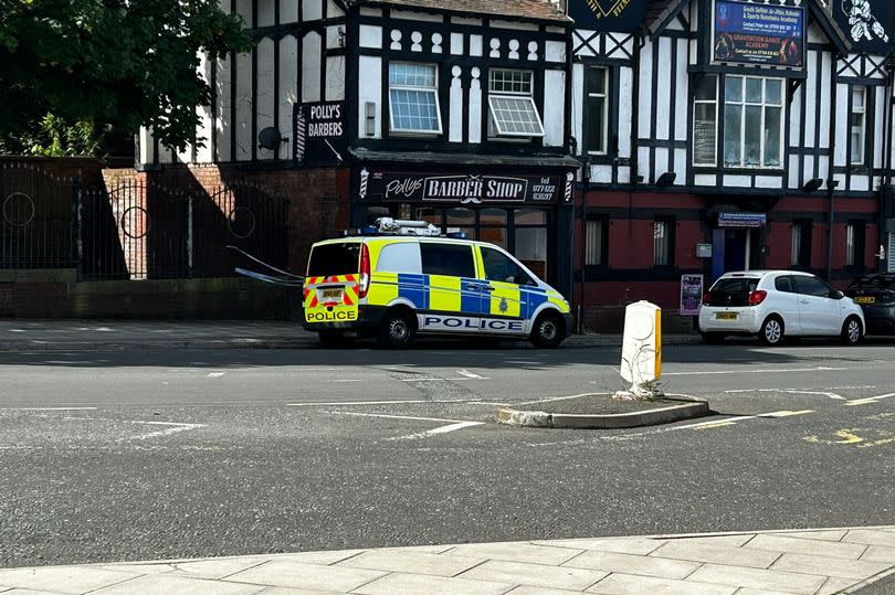 A small cordon and police van on Bridge Road in Litherland