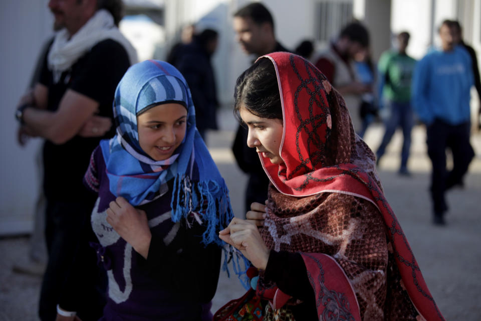 Malala Yousafzai, right, speaks with Mzoun Mlihan, 16, a Syrian refugee from Daraa city in Syria, during her visit to Zaatari refugee camp near the Syrian border, in Mafraq, Jordan, Tuesday, Feb. 18, 2014. A teenage Pakistani activist who came to the international limelight when she was shot by the Taliban said Tuesday that the plight of Syrian refugee children deprived of proper education was a stark reminder of the “dark days” Pakistani children under their hard-line rulers. (AP Photo/Mohammad Hannon)