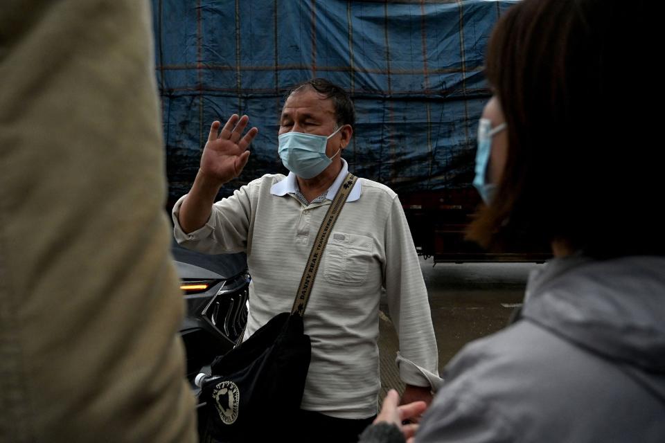 A relative of a passenger gestures as he leaves Lu village which leads to the crash site (AFP via Getty Images)
