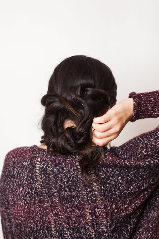 Lift the ends of your style up and loop hair into itself.