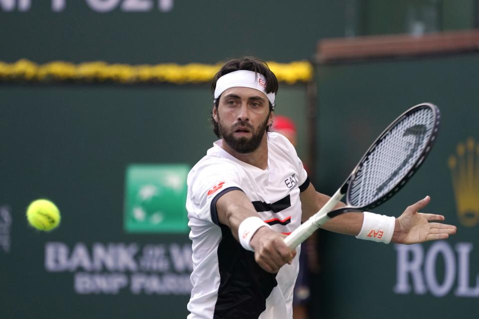 Nikoloz Basilashvili returns to Taylor Fritz in a BNP Paribas Open semifinal match Oct. 16, 2021.