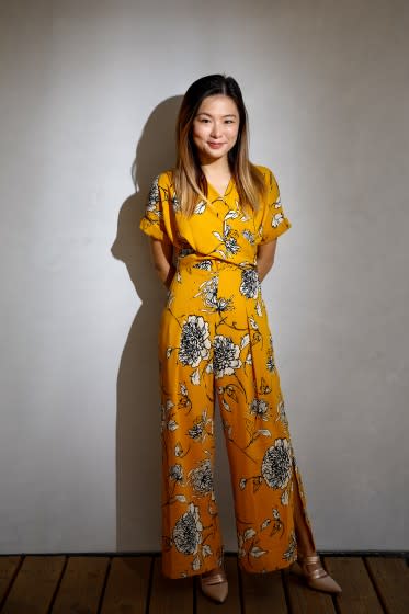 Jenny Wong, new associate artistic director of the Los Angeles Master Chorale, poses in a floral romper over a gray backdrop