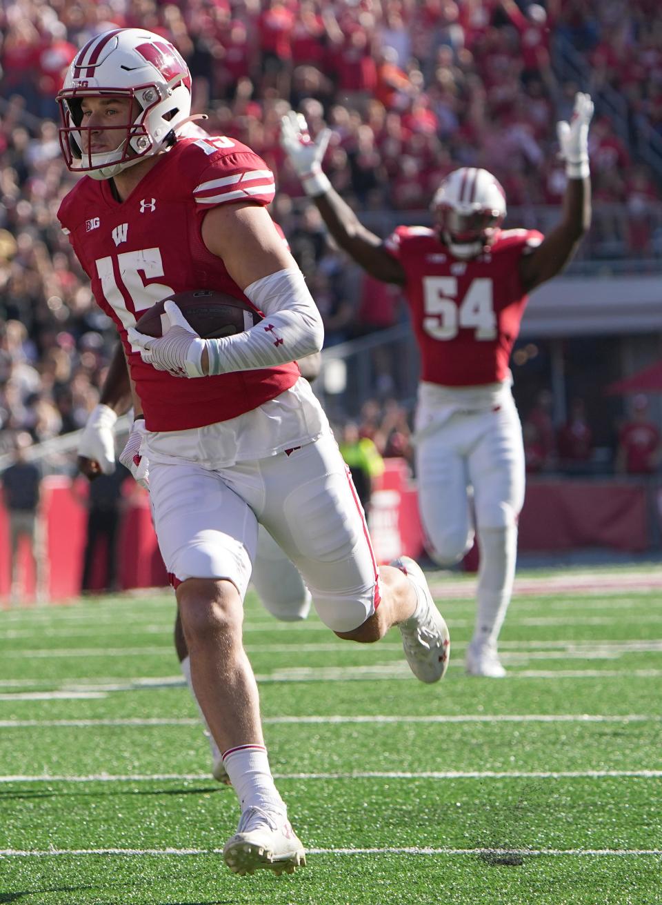 Wisconsin safety John Torchio (15) scores a touchdown after intercepting a pass thrown by Purdue quarterback Aidan O'Connell during the first quarter of their game at Camp Randall Stadium Saturday, October 22, 2022 in Madison, Wis.