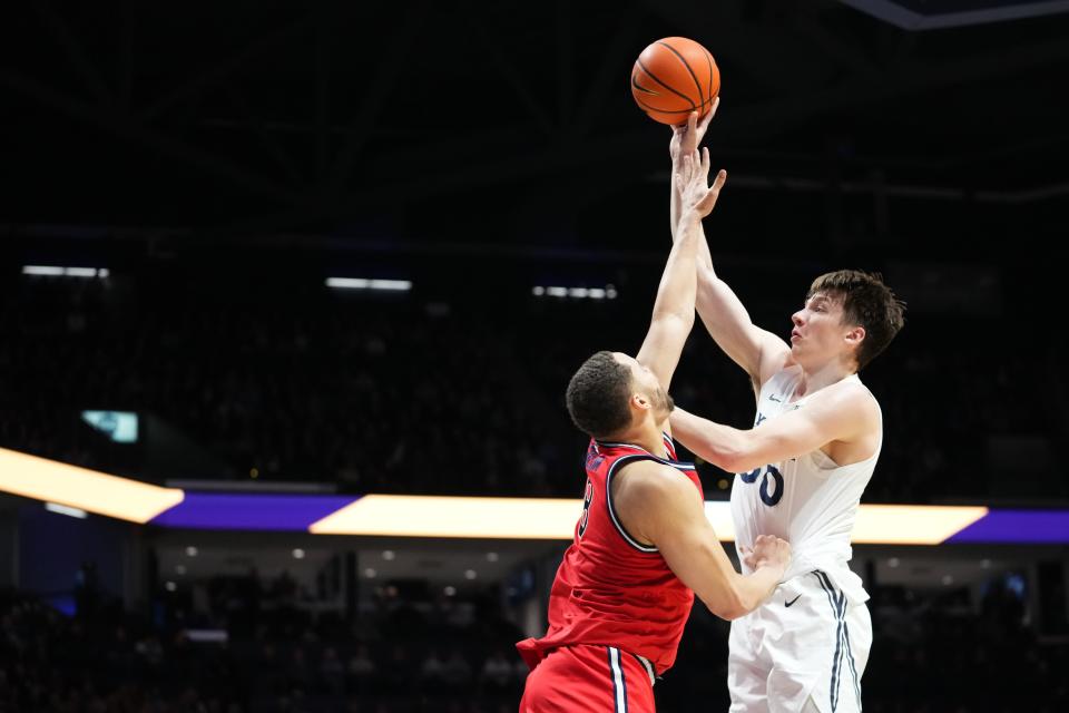 Xavier Musketeers forward Gytis Nemeiksa (50) rises to the basket over St. John's Red Storm guard Chris Ledlum (8) in the first half of a college basketball game between the St. John's Red Storm and the Xavier Musketeers, Wednesday, Jan. 31, 2024, at Cintas Center in Cincinnati.