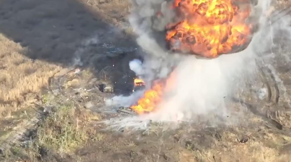 Russian vehicles in a field smoke with a big explosion