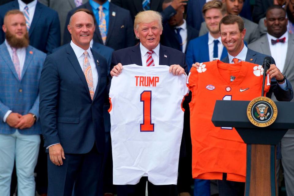 Jun 12, 2017; Washington, D.C., USA; United States President Donald Trump (center) holds up a Clemson Tigers football jersey along with Clemson University president James P. Clements (left) and head coach Dabo Swinney (right) on the White House South Lawn during a ceremony to celebrate their 2016 NCAA Football National Championship. Mandatory Credit: Rafael Suanes-USA TODAY Sports