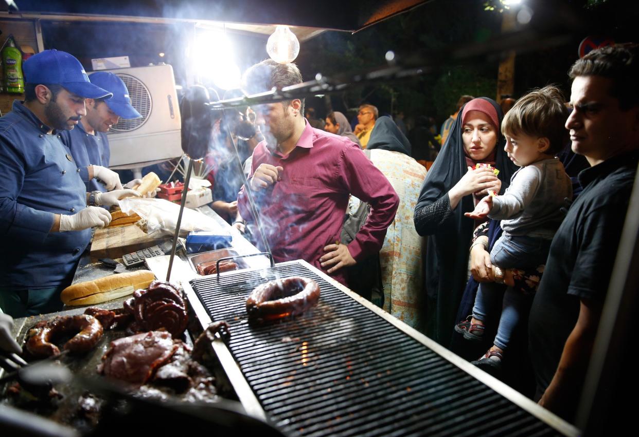 Iranians at a street food market in Tehran last month: EPA
