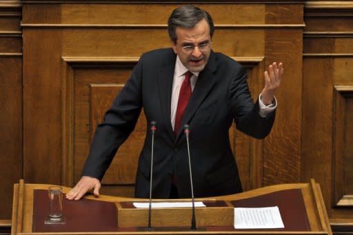 Greek Prime Minister Antonis Samaras gives a final speech at the Greek parliament in Athens. The coalition government of Samaras won a largely symbolic confidence vote on Sunday, picking up a comfortable mandate to tackle the country's two-year-old crisis