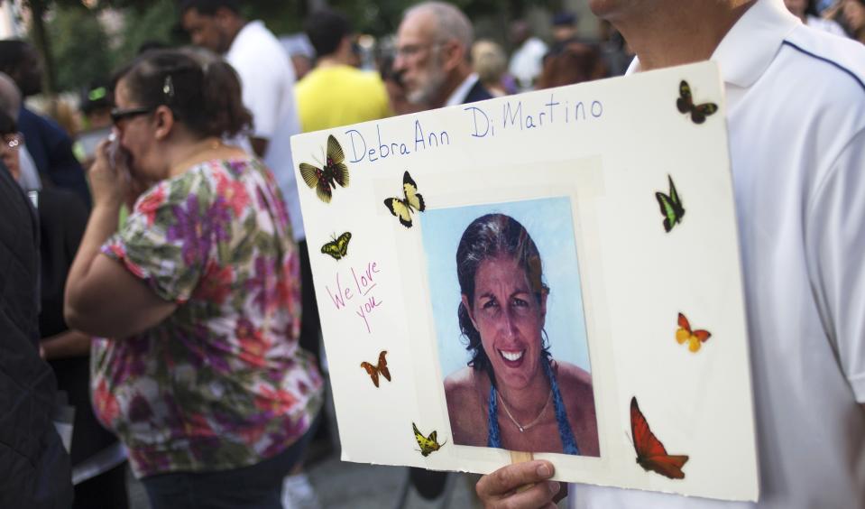 John Cirmia, the brother-in-law of DebraAnn DiMartino, clutches her image ahead of the 9/11 Memorial during ceremonies marking the 12th anniversary of the 9/11 attacks on the World Trade Center in New York on September 11, 2013. (REUTERS/Adrees Latif)