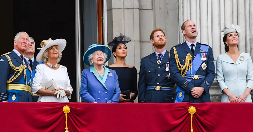 The Queen watches the Trooping the Colour event with Prince Charles, Prince Andrew, Camilla, Meghan Markle, Prince Harry, Prince William and Kate Middleton. 