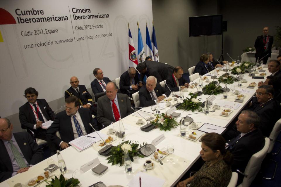 Spain's King Juan Carlos, third left, next to Spanish Foreign Minister Jose Manuel Garcia-Margallo, fourth left, and Spanish Prime Minister, Mariano Rajoy, second left, during a meeting at the XXII Iberoamerican summit in the southern Spanish city of Cadiz, Saturday, Nov. 17, 2012. Spain's King Juan Carlos opened the annual Iberoamerican summit, which brings together the heads of Spain and Portugal and the leaders of Latin America to discuss political issues and arrange business deals. (AP Photo/Miguel Gomez)