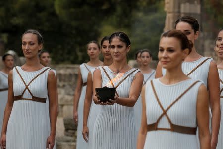 Olympics - Lighting Ceremony of the Olympic Flame Pyeongchang 2018 - Ancient Olympia, Olympia, Greece - October 24, 2017 Actresses with the flame during the Olympic flame lighting ceremony for the Pyeongchang 2018 Winter Olympics REUTERS/Alkis Konstantinidis