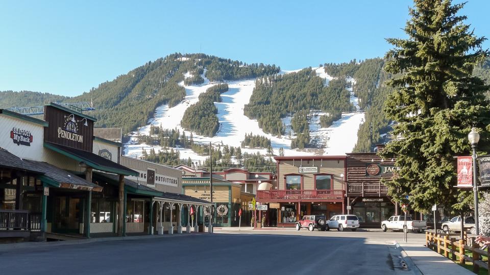 Jackson Hole, WY, USA - May 13, 2008: Ski slopes in Jackson Hole with panorama of vintage houses.