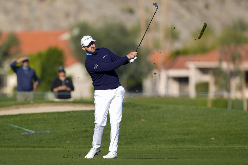 Patrick Cantlay watches his second shot on the first hole of the La Quinta Country Club course during the first round of the American Express golf tournament, Thursday, Jan. 18, 2024, in La Quinta, Calif. (AP Photo/Ryan Sun)