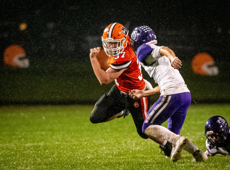 Byron's Caden Considine tries to run past Dixon's Tyson Dambman in the first quarter of their game on Friday, Oct. 13, 2023, in Byron.