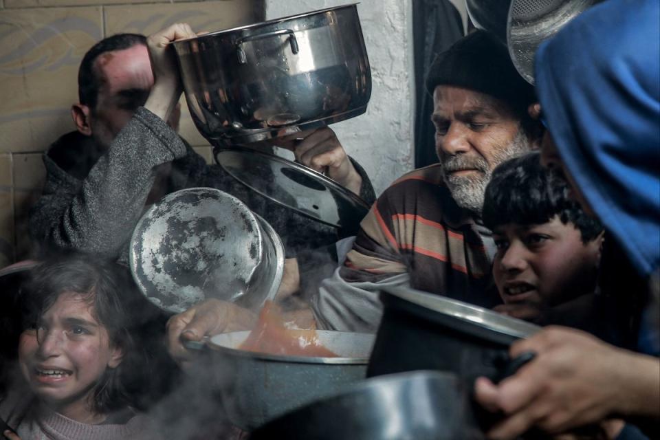 Gazans, many of which are believed to be on the brink of famine, gather to collect aid food in Beit Lahia on Monday (AFP via Getty Images)