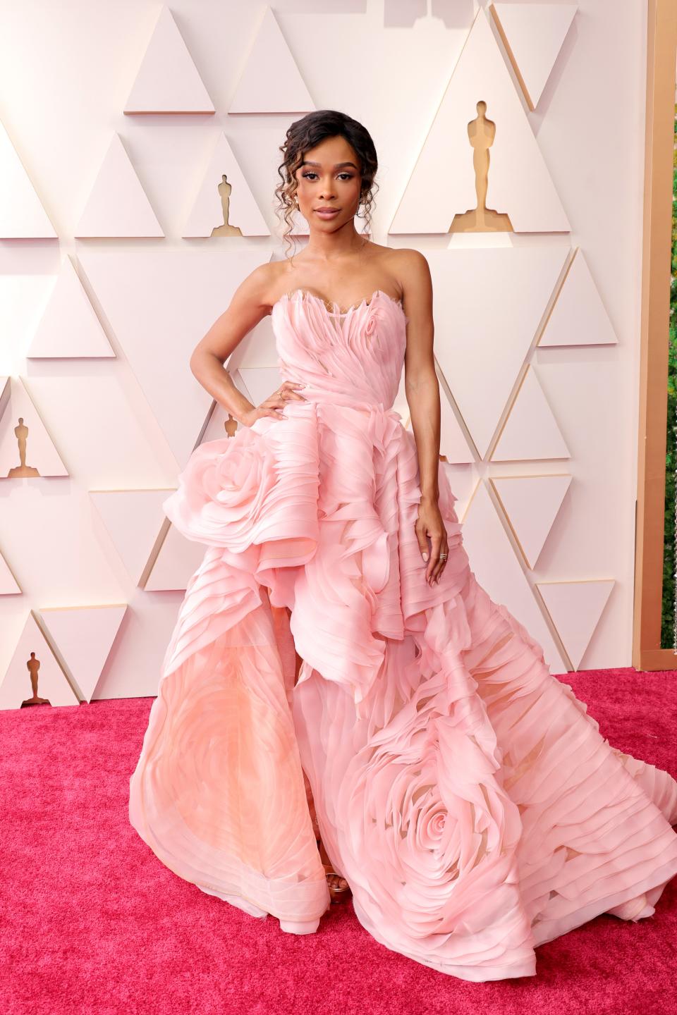 Zuri in a pink strapless voluminous gown with 3D flower petal detailing throughout.