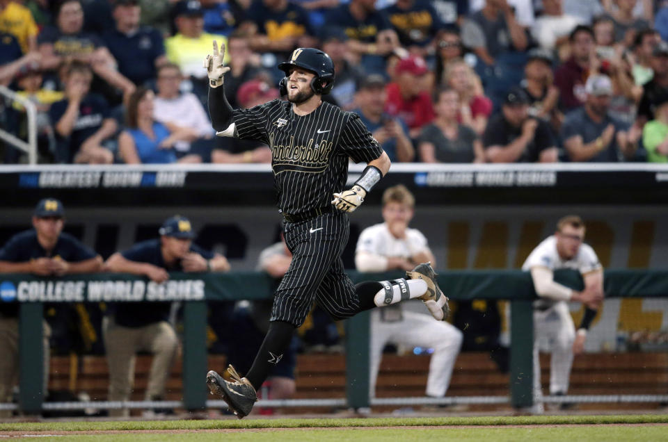 Vanderbilt's Philip Clarke, center, celebrates his solo homer in the seventh inning against Michigan in Game 2 of the NCAA College World Series baseball finals in Omaha, Neb., Tuesday, June 25, 2019. (AP Photo/Nati Harnik)