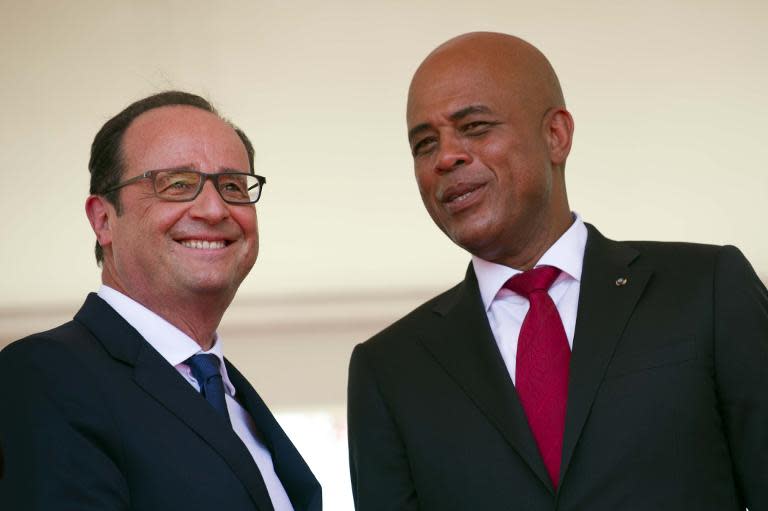 Haiti President Michel Martelly (right), pictured with French President Francois Hollande, is constitutionally barred from seeking a second term in office