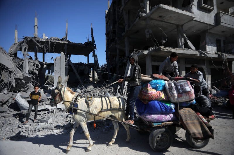 Palestinians take what is left of their belongings from their destroyed house following overnight Israeli airstrikes in town of Rafah, southern Gaza Strip, on Saturday on April 20. Most of Gaza's 2.5 million population has been re-located near southern Gaza. Photo by Ismael Mohamad/UPI