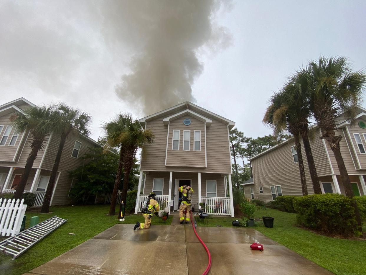 South Walton Fire District firefighters respond to a fire at  a two-story home on Enchanted Way in Santa Rosa Beach. The fire was believed to be caused by a lightning strike.