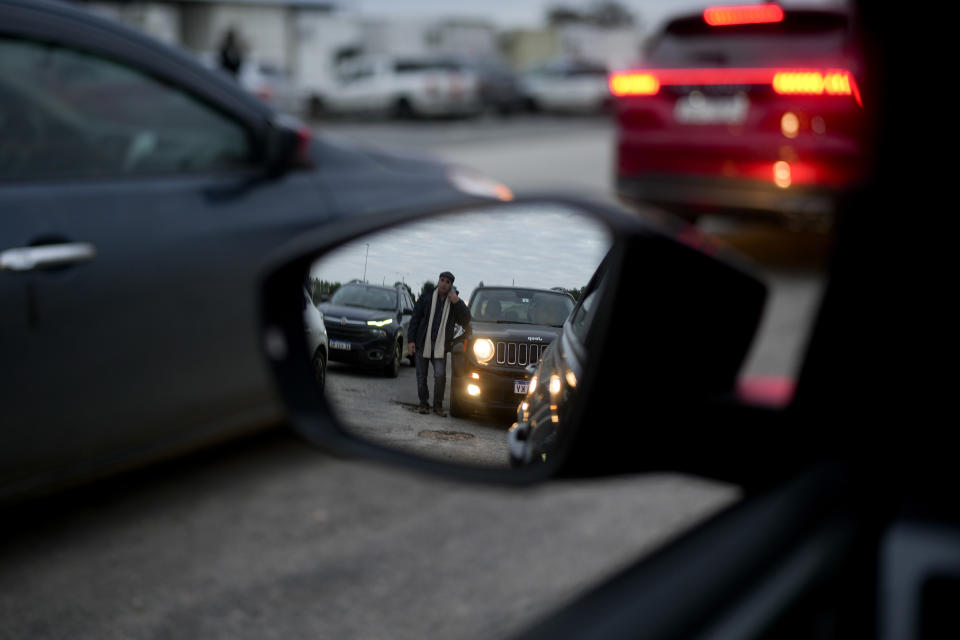 Cars wait in line to to enter Argentina from the Uruguayan border near Fray Bentos, Uruguay, Friday, June 30, 2023. Uruguayans are crossing the border to Argentina for shopping bargains created by different exchange rates in the South American countries as crisis-battered Argentina’s peso has plunged against the U.S. dollar and its annual inflation tops 100%, one of the highest rates in the world. (AP Photo/Natacha Pisarenko)