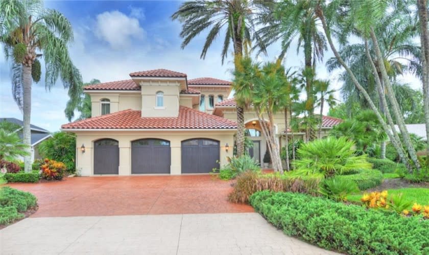 Custom-built in 2002, the four-bedroom home opens to a massive lanai with electric shutters.