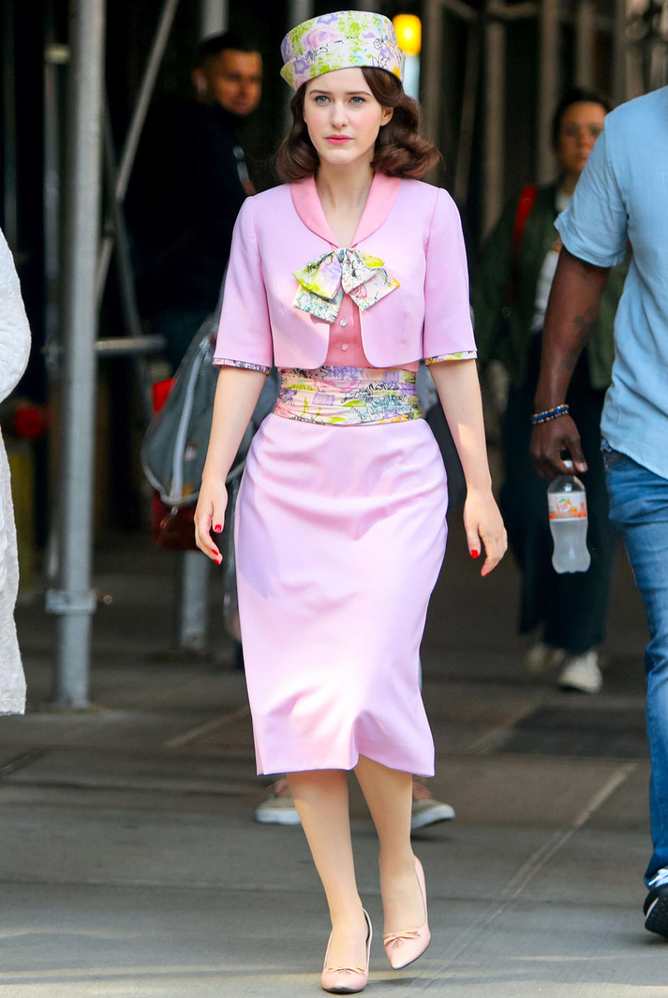 <p>Brosnahan sports a pink floral ensemble with a matching hat while filming on June 1. </p>